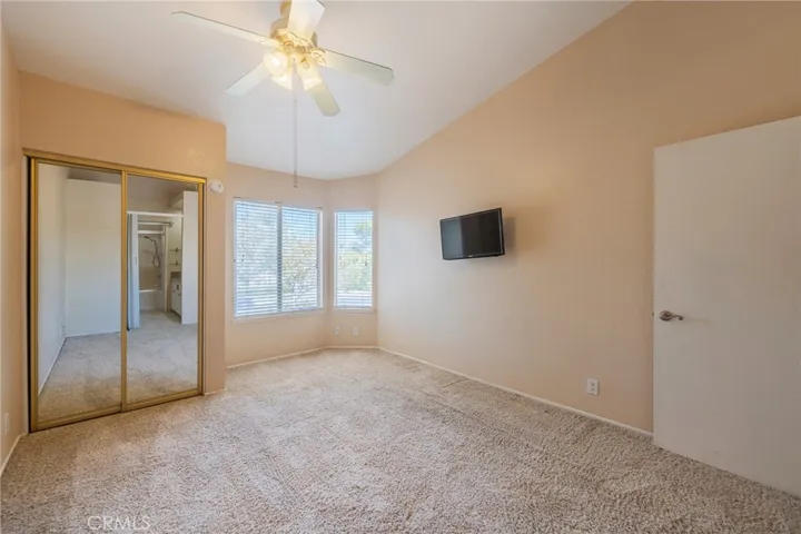 A spacious master bedroom with a view of the stunning RSM community and a glimpse of Saddleback Mountain
