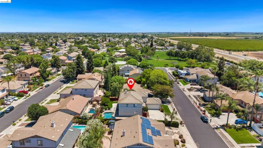 Aerial perspective of a residential neighborhood with tree-lined streets