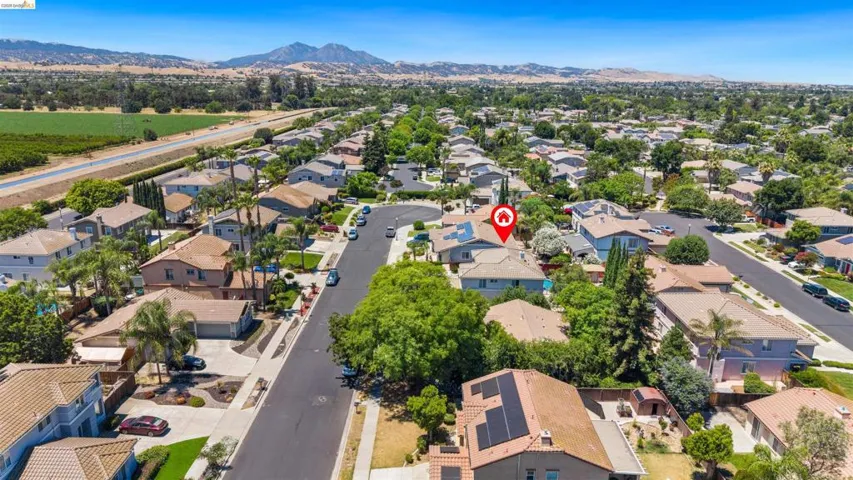 Aerial perspective of a residential neighborhood with a mountain backdrop