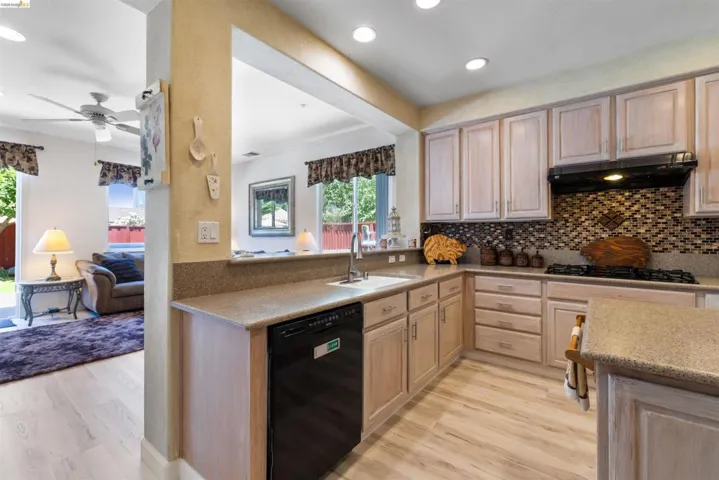 Kitchen featuring wood-finish flooring and light-toned cabinetry