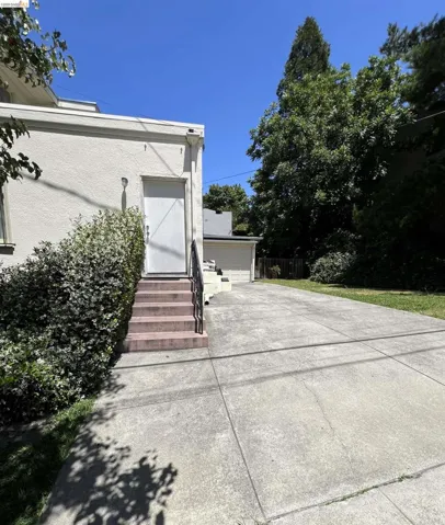 Concrete driveway extending to a detached garage