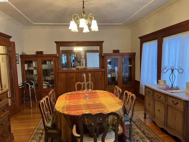 Formal dining area featuring wood-finish flooring and an ornate ceiling medallion