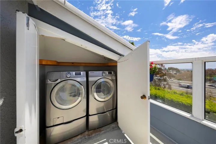 Full size washer & dryer in closet on balcony