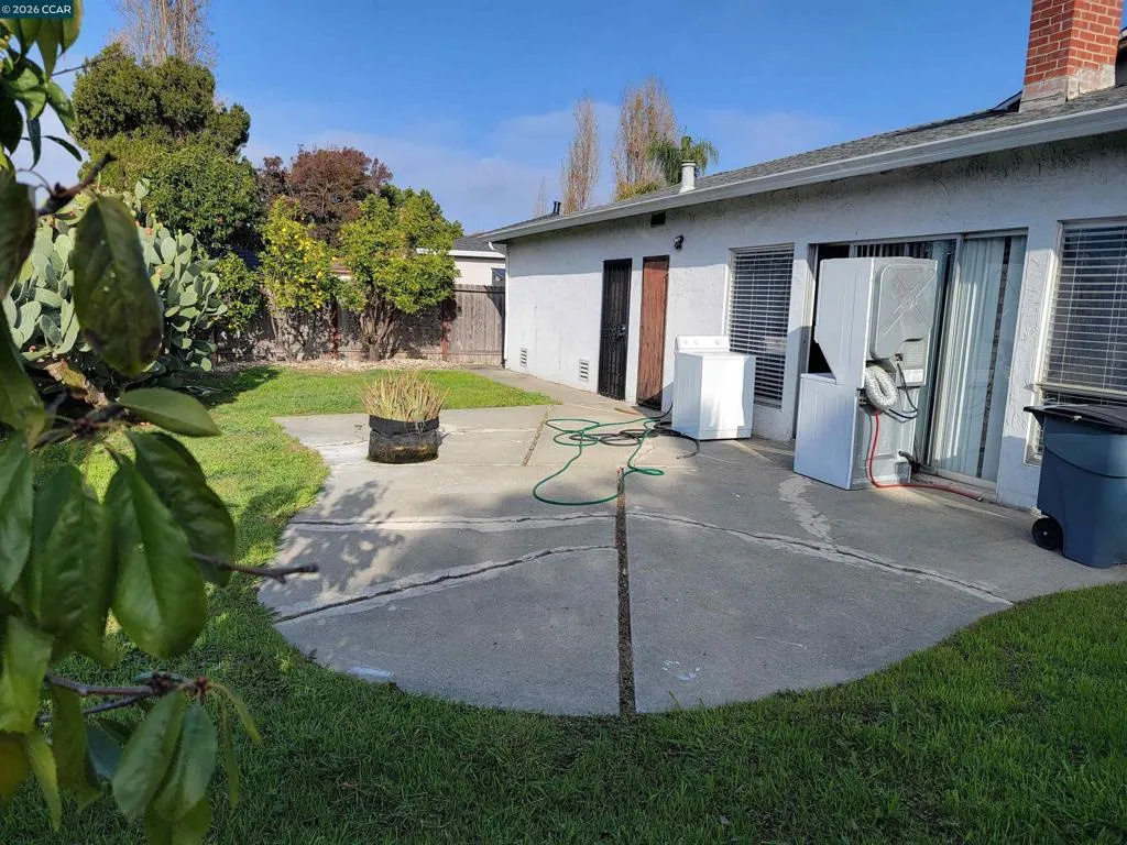 BACKYARD W/DOORS TO GARAGE & KITCHEN