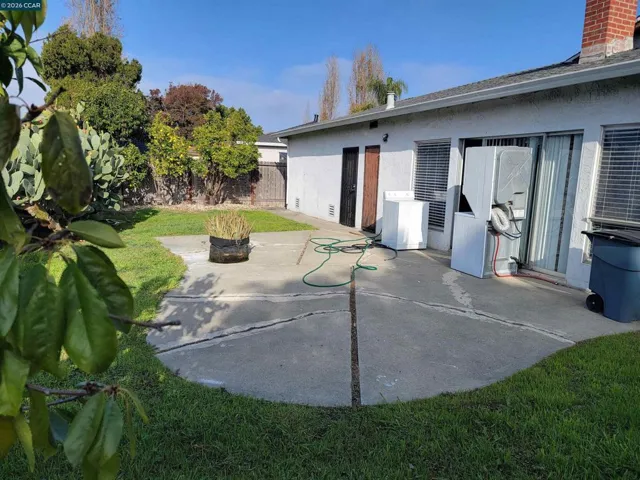 BACKYARD W/DOORS TO GARAGE & KITCHEN