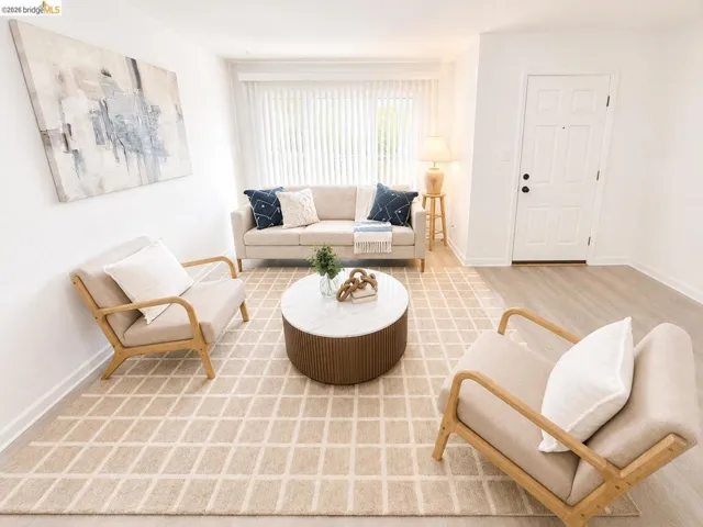 Bright living area featuring light wood-finish flooring