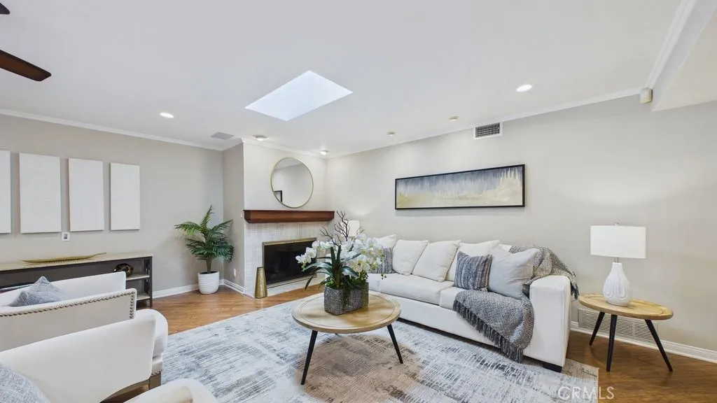 View of the living area with fireplace and skylight
