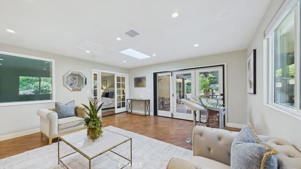 View of family area that overlooks the patio and pool with easy access to the primary bedroom on the Left.