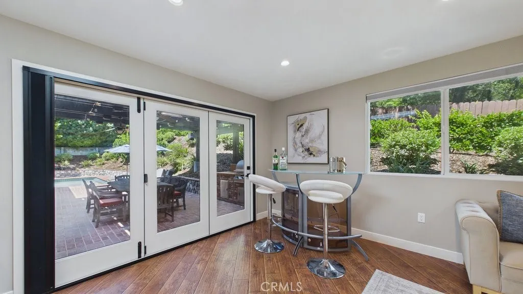Spacious family room featuring an open-concept flow to the patio and pool area.