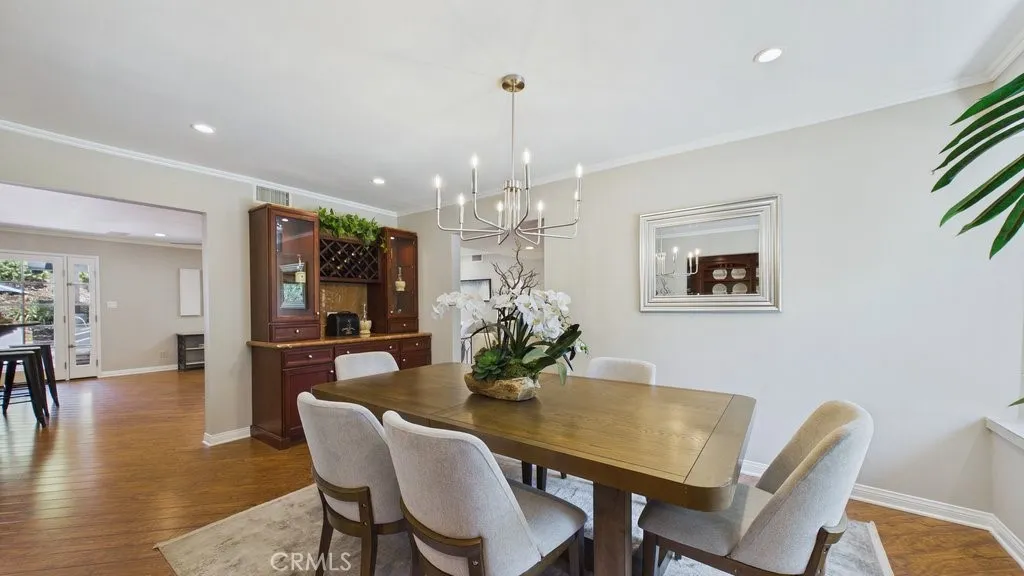 Formal dining area view from the butler's pantry, featuring the kitchen entrance on the left.