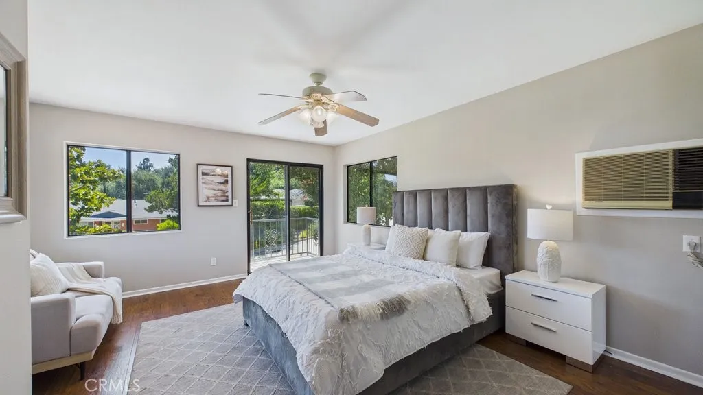 Spacious fourth bedroom located on the second level, featuring a private 3/4 bathroom and a personal balcony.