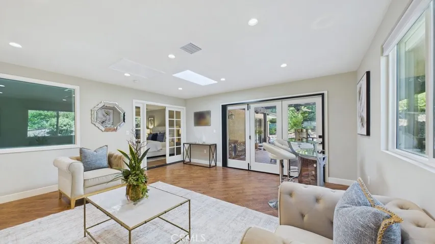 View of family area that overlooks the patio and pool with easy access to the primary bedroom on the Left.