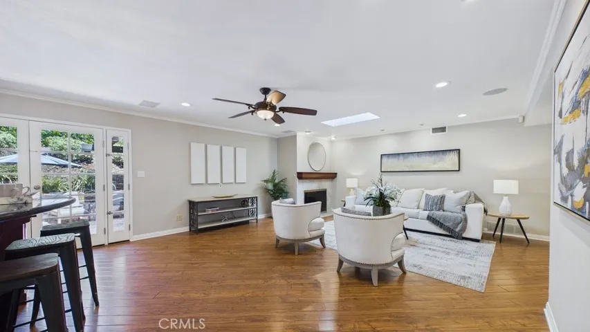 View of the living area as seen from the kitchen with French doors on the Left leading to the patio and pool area.