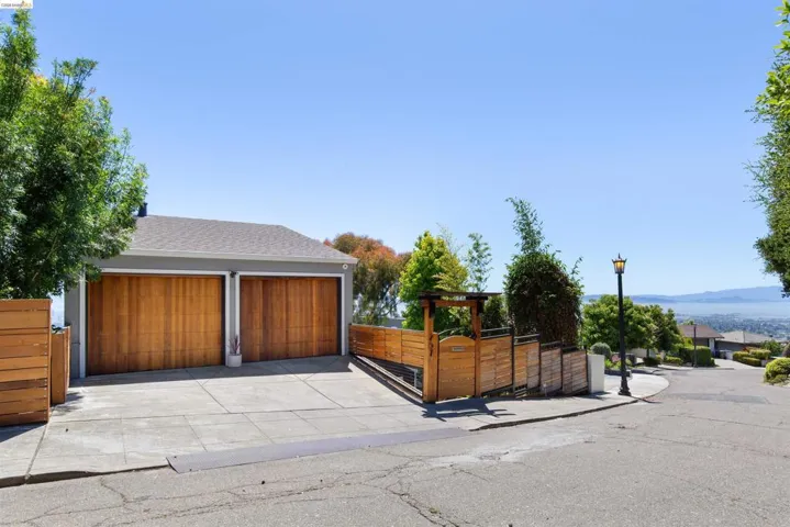 Two-car garage with wood-finish doors at street level with interior access