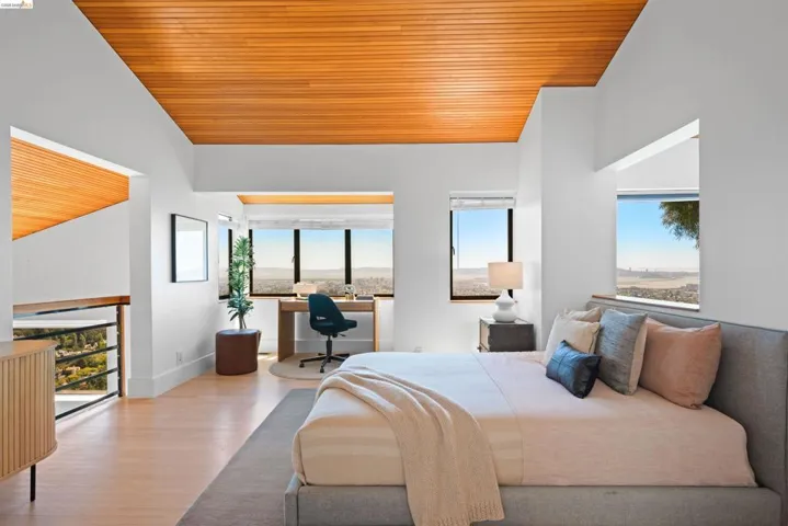 Vaulted wood-paneled ceiling with recessed lighting. This room is open to the kitchen and living area below