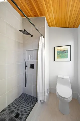 Modern bath featuring a wood-paneled ceiling
