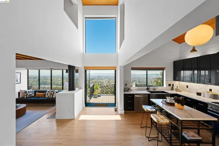 Expansive interior featuring high ceilings with wood-finish accents, large format windows, and wood-finish flooring