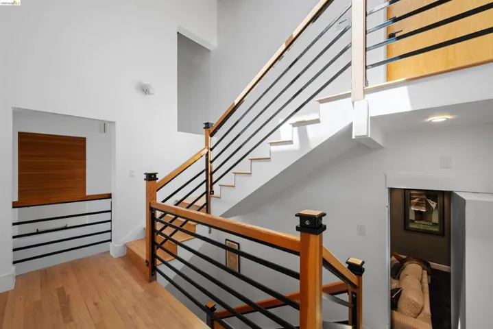 Modern staircase with natural wood handrails and black metal balusters