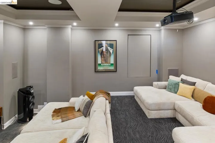 Dedicated media room tucked behind a recessed door in the stairwell