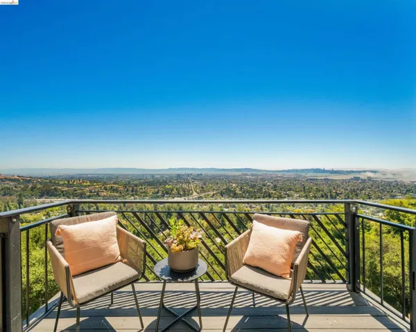 Expansive deck featuring a metal railing and composite decking