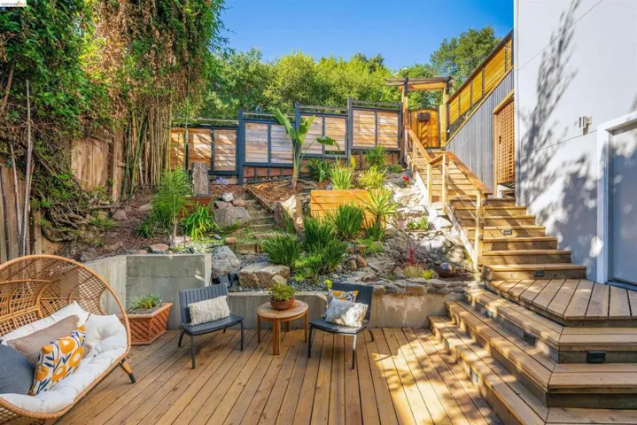 Multi-level wooden deck featuring integrated stair lighting and a terraced garden
