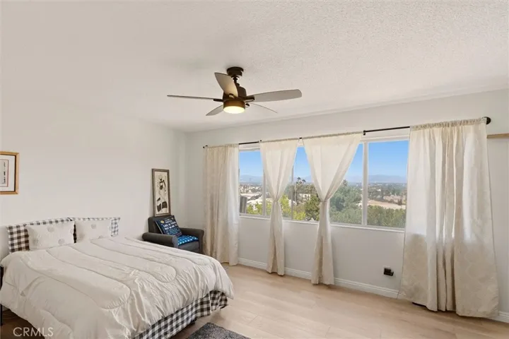 Primary suite with hardwood floors and natural light.