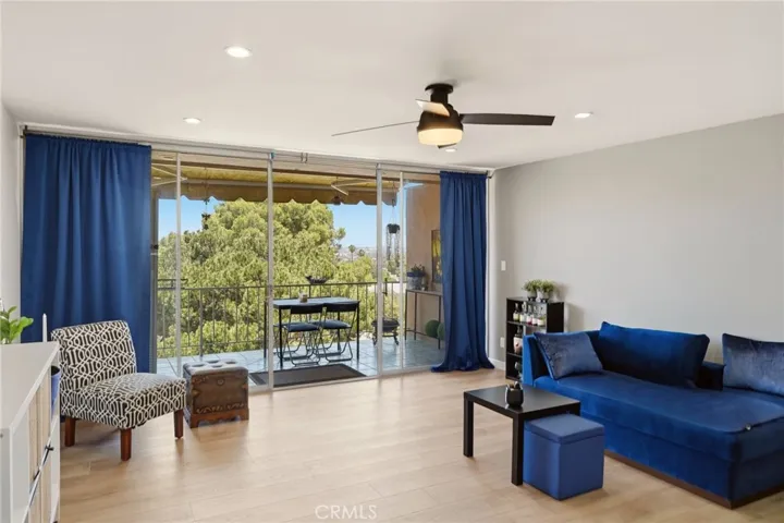 Living area open to dining and balcony sliders.