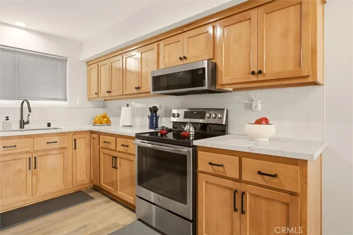 Quartz counterops and ample storage in the remodeled kitchen.