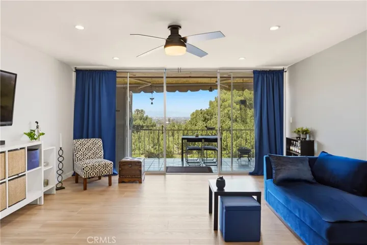 Living room with hardwood floors and balcony access.