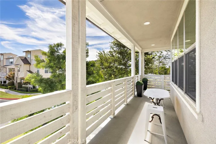Extended balcony expanding living space with peaceful neighborhood vistas.