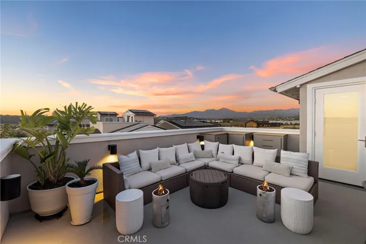 Sky lounge glowing at dusk with open-air comfort and stylish seating.