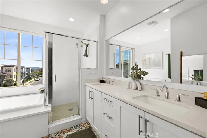 Spacious primary bath with dual vanity and airy layout.