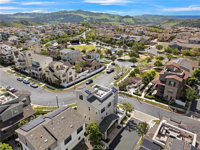 Elevated aerial capturing rooftop living and walkability to picnic and nearby park.