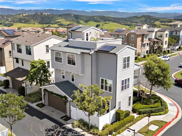 Wide aerial view emphasizing the rare corner-lot setting and community surroundings.