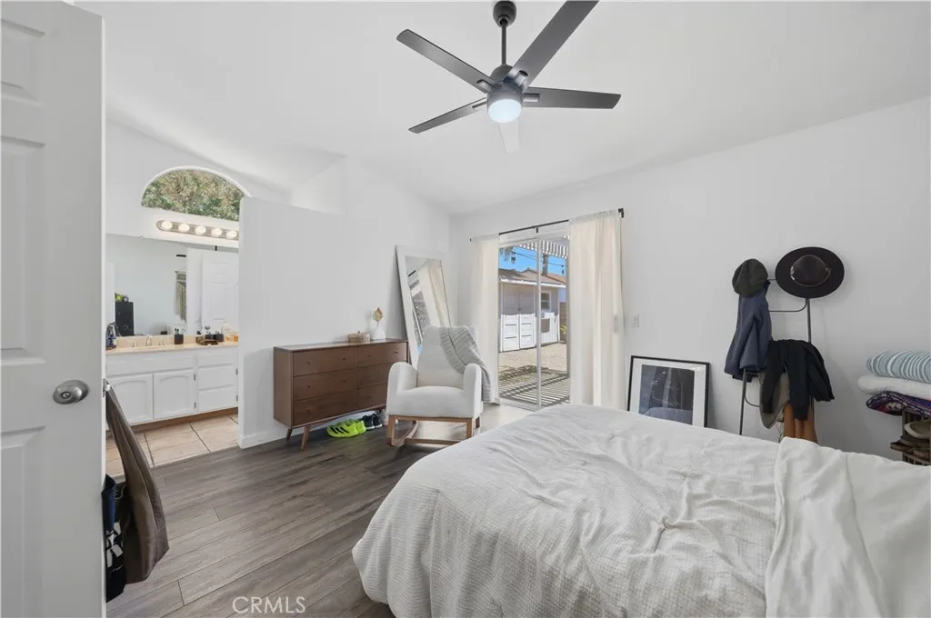 The spacious primary suite offers a peaceful retreat with direct patio access and a seamless connection to the ensuite bathroom.