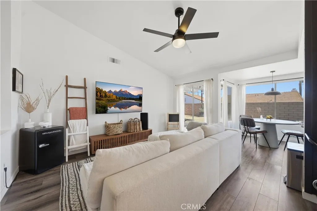A comfortable family room opens to the dining area and patio, creating a bright and connected space for everyday living and entertaining.