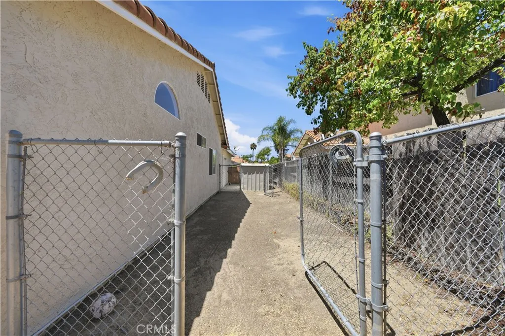 A gated side yard offers additional outdoor space with convenient access for storage, pets, or utility use.