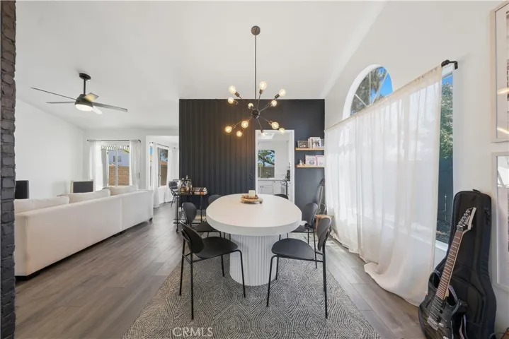 A spacious dining area filled with natural light seamlessly connects to the main living spaces, creating an ideal setting for everyday living and entertaining.