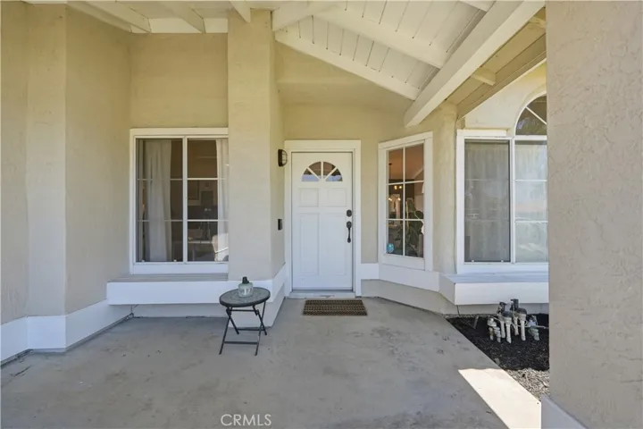 A covered front porch with vaulted ceilings creates a warm and inviting entry.