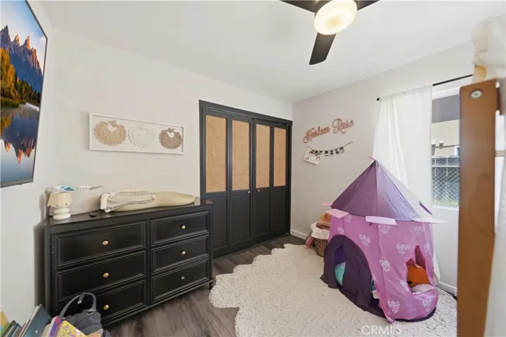 A spacious secondary bedroom offers flexibility for family, guests, or a home office, complete with a large closet and natural light.