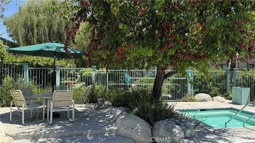 Hot tub and dining area in a park like setting.