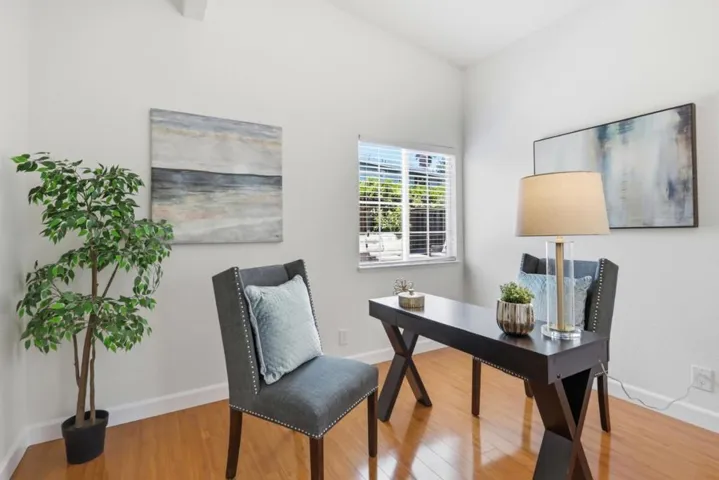 Versatile bedroom with vaulted ceiling, abundant natural light, and flexibility for a home office.