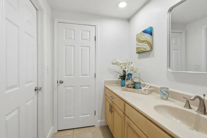 Expansive primary bathroom with extended vanity, generous counter space, and abundant storage.