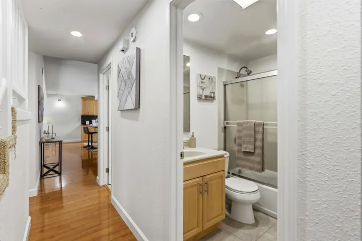 Full hall bathroom featuring a single-sink vanity and shower-over-tub combination.