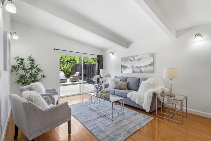 Bright family room with vaulted ceilings and sliding glass door leading to the backyard patio.