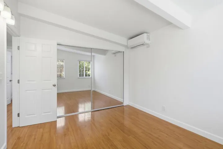 Nice bedroom offering mirrored closet doors, vaulted ceiling, and abundant natural light.