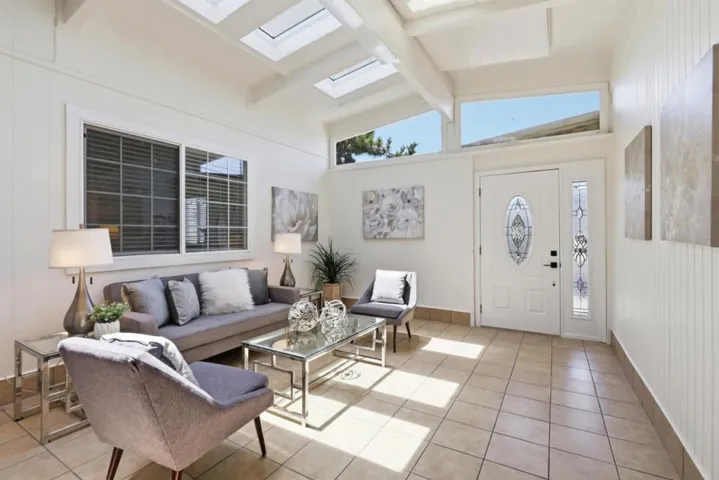Spacious sunroom offering a versatile space for relaxing, entertaining, or a home office.