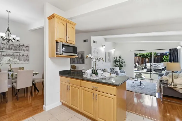 Open kitchen with breakfast bar flowing seamlessly into the family room, creating an ideal space.
