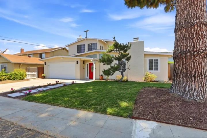 Inviting front entry with a vibrant red front door.