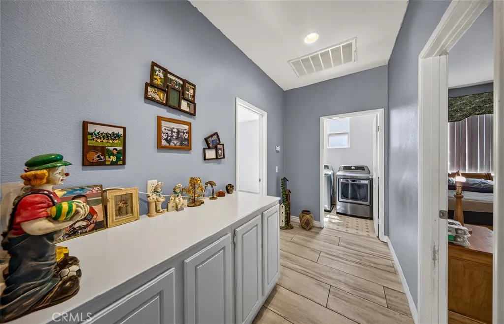 Hallway with additional linen storage.